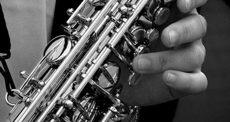 Close up imae ofa saxophone and hands.