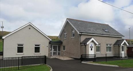 View of Dunluce Guide House from the front, further images of kitchen, TV room, twin room and dorm.