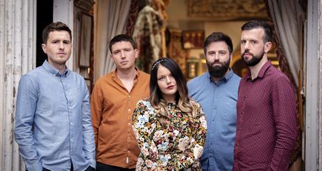 Image featuring the 5 members of the band Goitse standing in a door way.