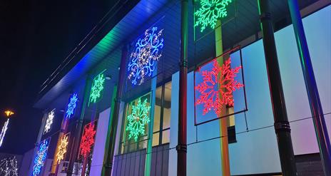 Colourful snowflakes line the side of the Roe Valley Arts & Cultural Centre building