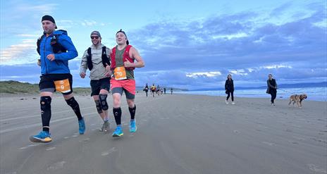 Giants Causeway Coast Marathon runners on beach