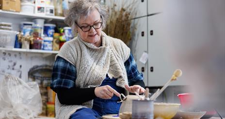 Patricia Millar working on a ceramic piece in her workshop.