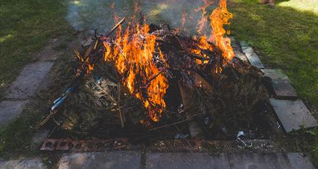 an earthen pit of flames used for firing pottery