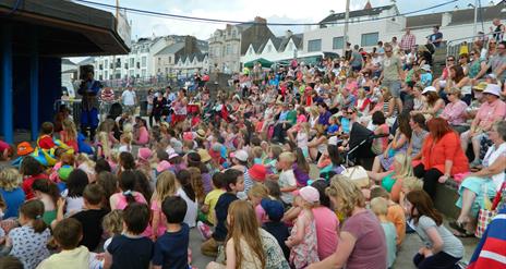a large crowd of people watching a performance at The Crescent in Portstewart
