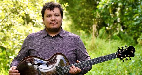 Man holding a traditional string instrument.
