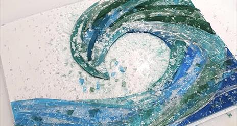 A beautiful wave made of various piece of glass and crystal.
