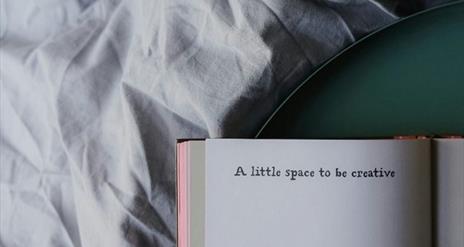 An opened book with the written words  'A little space to be creative'.