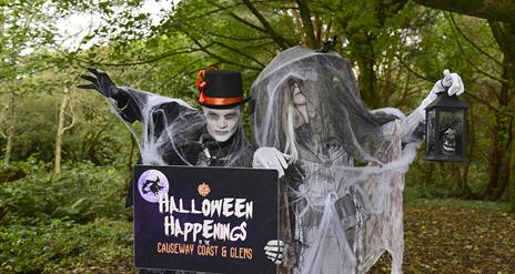 Image shows two spooky characters dressed up in the woods
