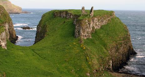 the ruins of Dunseverick Castle on a cliff along the Causeway Road