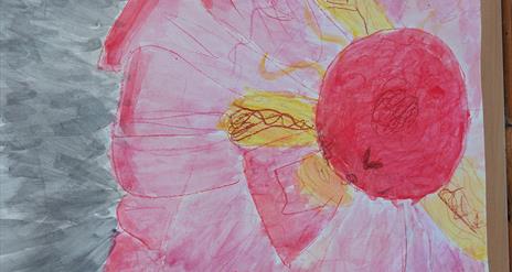 A pink hand painted flower with yellow petals.