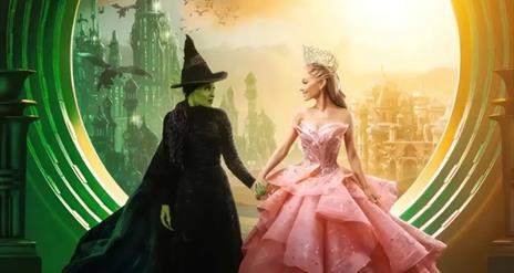 A scene from Wicked with the two main characters Elphaba and Galinda holding hands.
