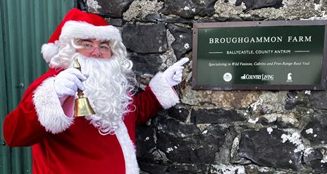 Christmas at Broughgammon Farm Ballycastle with Santa standing outside the building