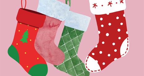 colourful christmas stockings on a pink background