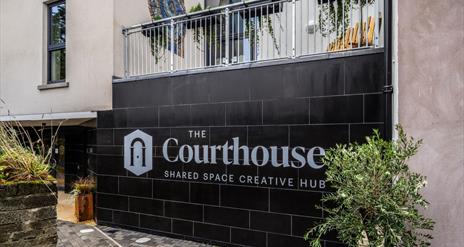 The Courthouse logo on a black tile wall, Bushmills.