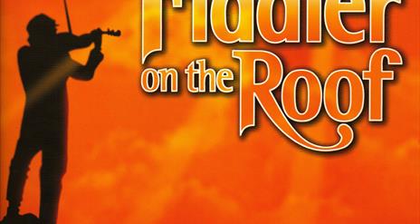 Man playing a fiddle on top of a mountain with the title 'Fiddler on the Roof'