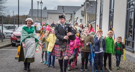 Ballycastle Community Parade led by a piper  in St Patrick's day 2018