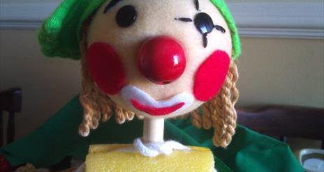 close up for a rod puppet's face that looks like an elf.