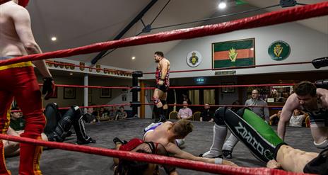 A number of wrestlers performing in ring at the Ballymoney Legion Hall.