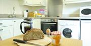 Wheaten bread, boiled egg and marmalade on kitchen table