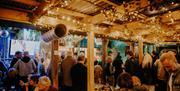 crowds of people gathered at an indoor bar at Atlantic Sessions