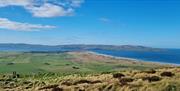 a panoramic view of the countryside and the sea on the Ulster Way