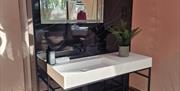 private bathroom with large freestanding stone sink and heated mirror