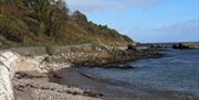 a railed path along the coastline of Cushendall Beach