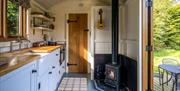 Hut interior showing kitchen and wood burning stove