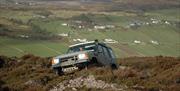 Land Rover driving through bog land