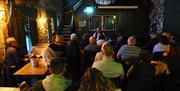 people gathered inside a bar as part of a tour group