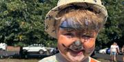 a young child with tiger face paint