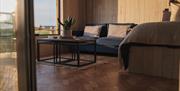 Image of inside the Hideaway cabin - sofa, bed and coffee table