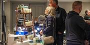 People browsing indoor market stalls