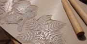 print making materials carved into snowflakes and mistletoe