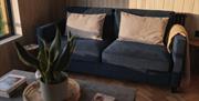 Image of navy sofa and coffee table at the cabin.