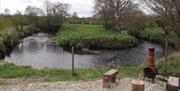 View of the river bend and chiminea seating area right outside the cabin doors