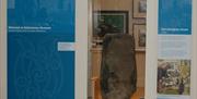 glazed exhibit of the ancient Derrykeighan Stone dating  (Iron Age c50AD) originally found locally at Derrykeighan Church walls.