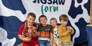 Children posing for a photo with a snake