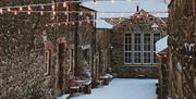 exterior of Limepark in the snow featuring a string of fair lights zigzagging between the buildings