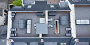 aerial view of rooftop terrace at DB Stays 'The Lookout' featuring hot tubs and lounge chairs