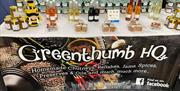 a market tall stable holds a selection of jams, chutneys and oils, with a branded 'Greenthumb HQ' table cloth