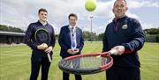 The organisers of Country Antrim Tennis Championships stand holding rackets