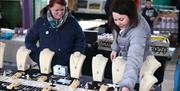 Two ladies browsing the stalls at the Naturally North Coast and Glens Artisan Market