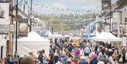 Crowds and stalls fill the main street in Bushmills
