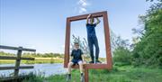 Boys posing on frame at Camus Wood