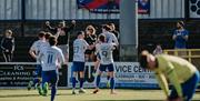 Coleraine FC celebrating on the pitch.