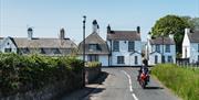 A motorbike on a road in the village of cushendun