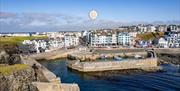 Photograph of Portstewart Harbour with a pin on the image marking the location of the Apartment within the Block.