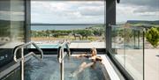 Indoor salt spa pool with panoramic sea views and outdoor terrace.