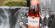 Photo of Jacuzzi hot tub with bottle of Champagne and 2 crystal glasses